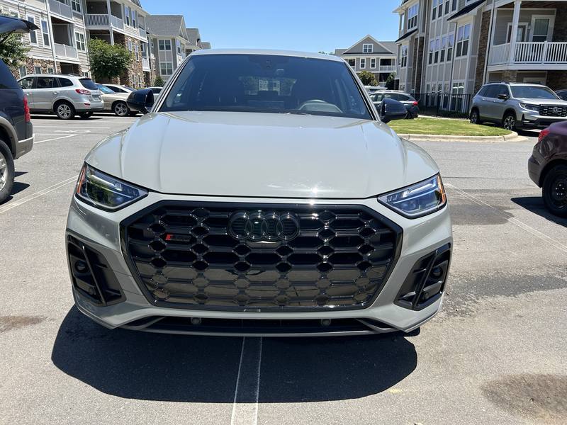 Mobile car detailing in Charlotte, NC: Front of a gray Audi SQ5 with a gloss black grille and clear LED headlights