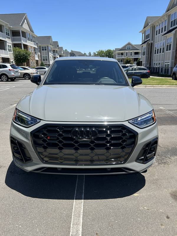 Mobile exterior detailing in Charlotte: Head-on view of a gray Audi SQ5 with clear headlights and a gloss black grille