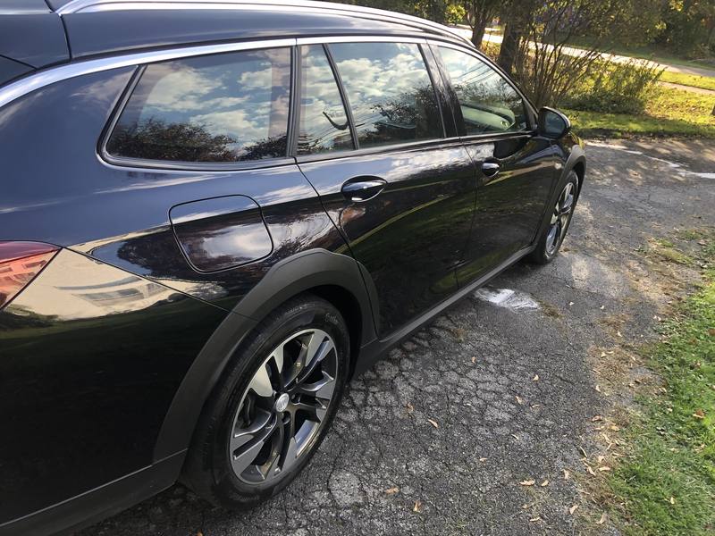 Mobile wash and wax in Charlotte: Black Buick Regal TourX with glossy paint reflecting the sky after a detail