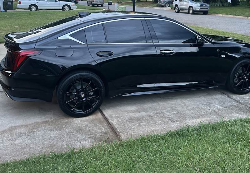 Mobile paint correction in Charlotte: Side of a glossy black Cadillac CT5 after a detail