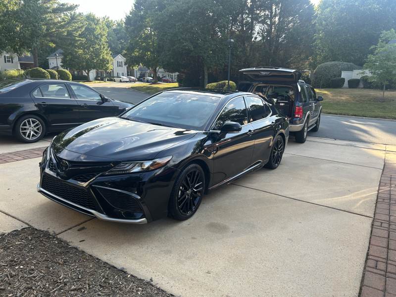 Mobile car detailing in Charlotte, NC: Black Toyota Camry with a fresh exterior detail in a driveway