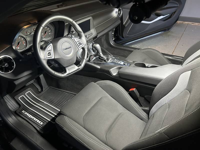 Mobile car detailing in Matthews, NC: Chevy Camaro driver seat, steering wheel, and dash after an interior detail