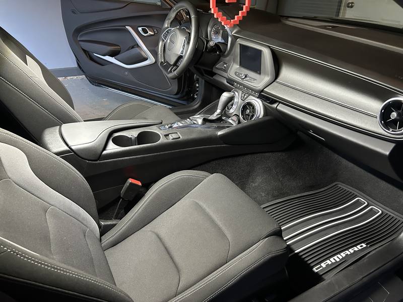 Mobile interior detailing in Charlotte: Chevy Camaro passenger seat, center console, and floor mat after an interior detail