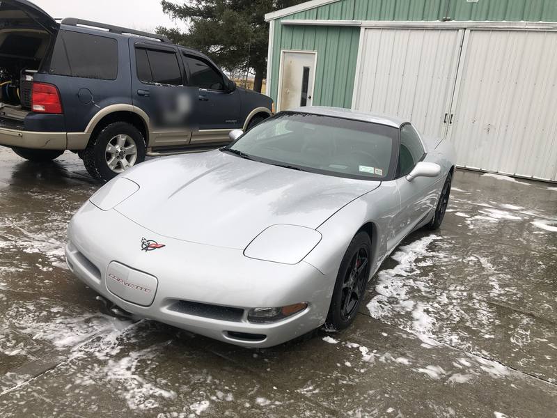 Mobile exterior detailing in Charlotte: Silver C5 Corvette after a hand wash, parked next to a mobile detailing SUV