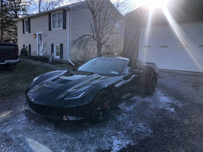 Mobile paint correction in Charlotte: Black C7 Corvette Stingray parked in a gravel driveway after a detail