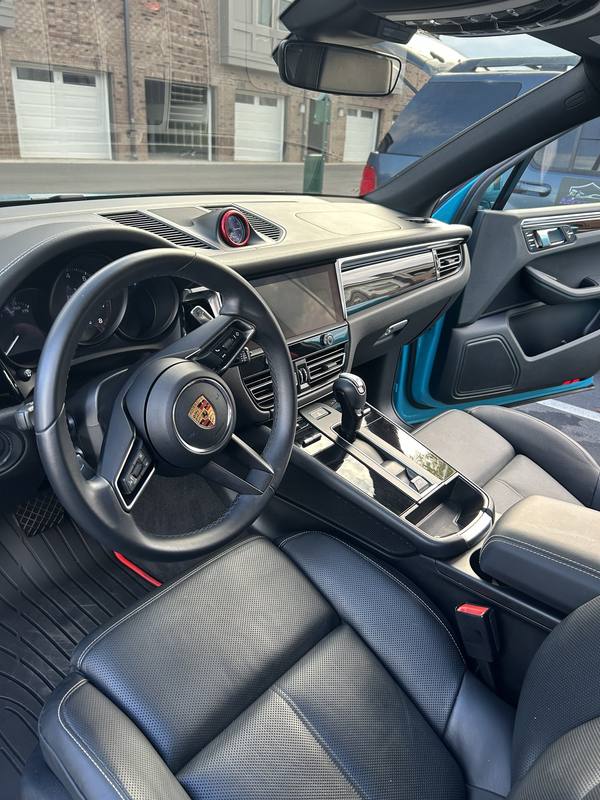 Mobile interior detailing in Charlotte: Porsche Macan black leather seats and dashboard after an interior detail