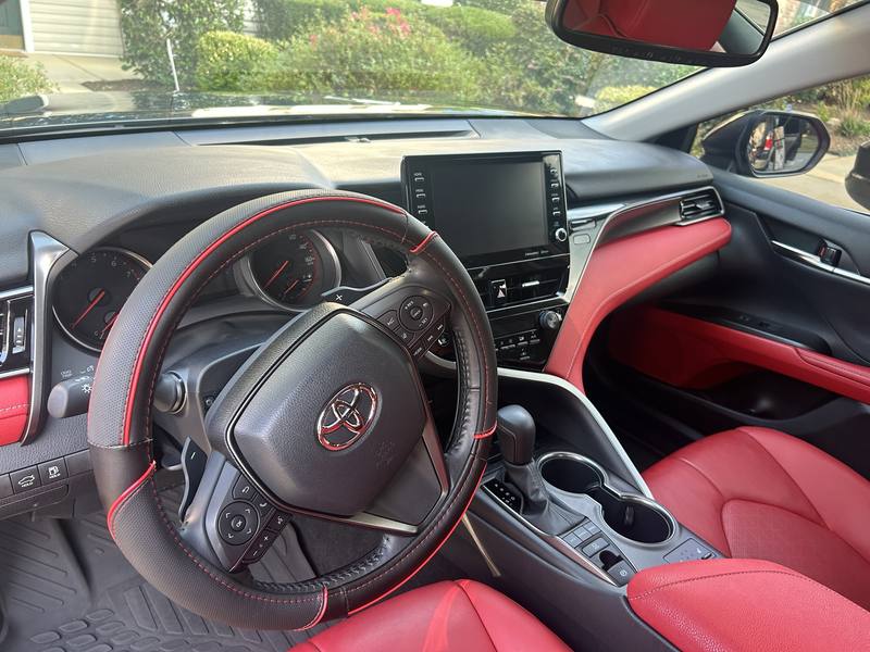 Mobile interior detailing in Charlotte: Toyota Camry dashboard, steering wheel, and center console after an interior detail