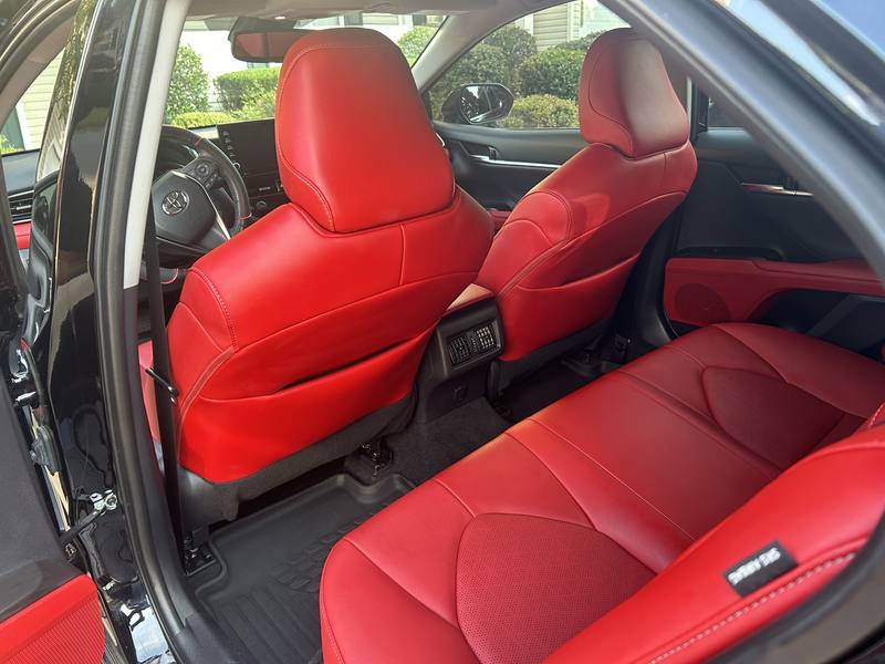Mobile interior detailing in Charlotte: Toyota Camry red leather back seats and rear floor mats after an interior detail
