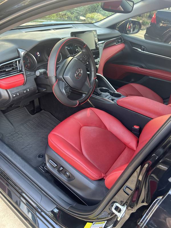 Mobile car detailing in Charlotte, NC: Toyota Camry red leather driver seat and dashboard after an interior detail
